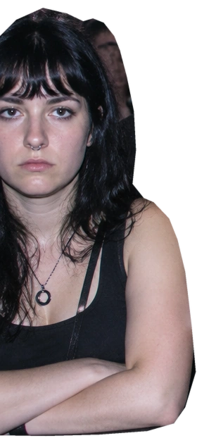 An unimpressed woman stands with her arms folded.